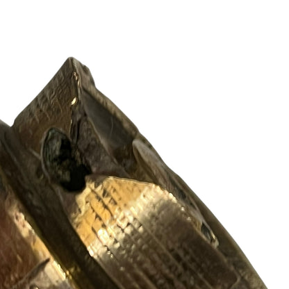 Close up of WW1 relic brass fuse on a white background