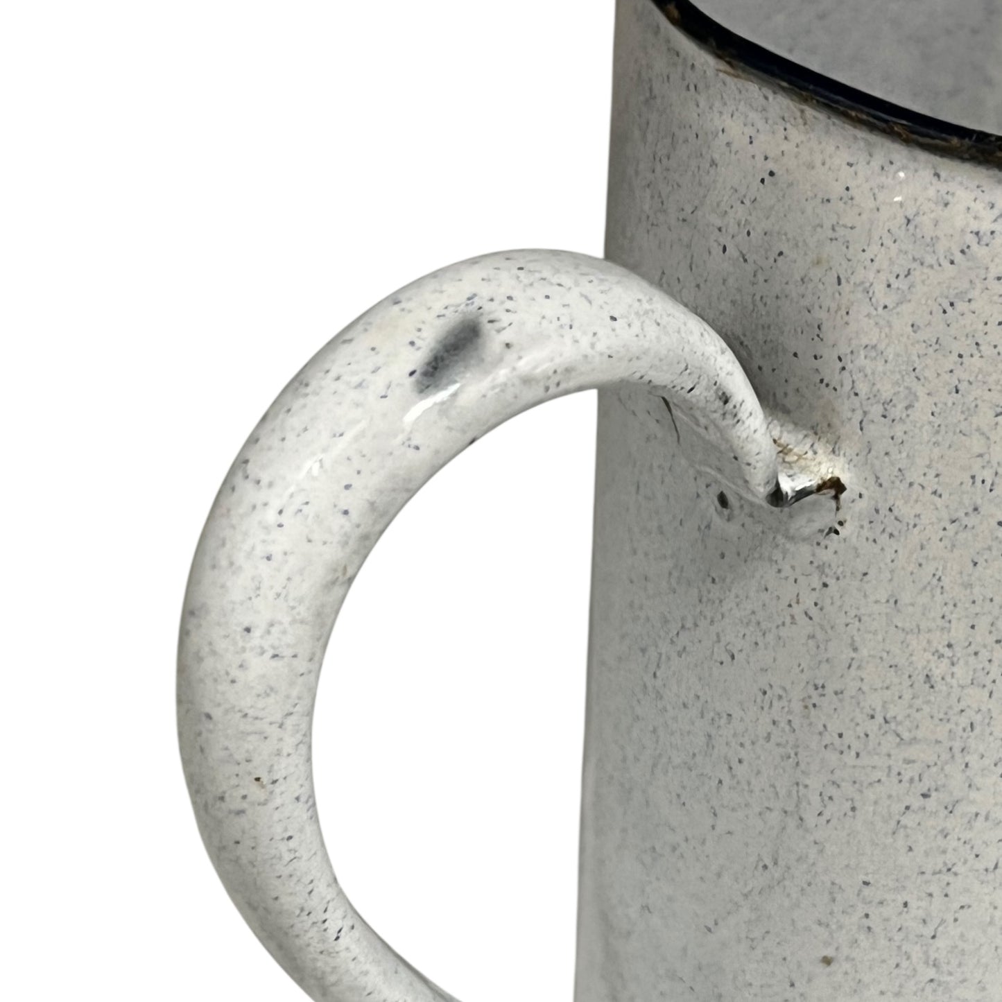 Close-up of an enamel jug with a speckled texture and handle on a white background