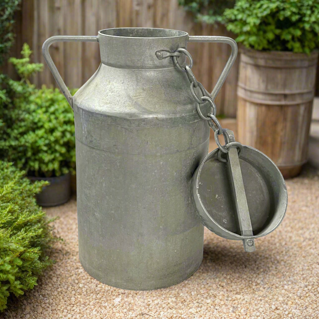 Vintage French metal milk churn on a white background