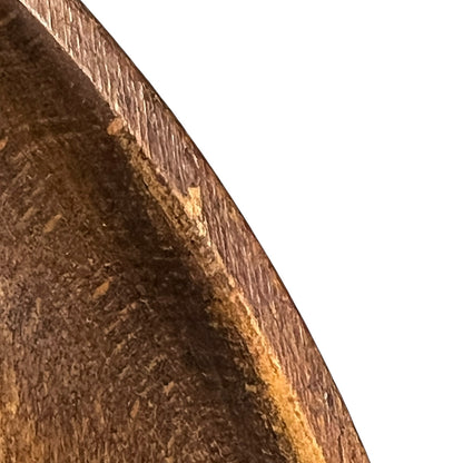 close up of a wooden decorative round plaque on a white background 