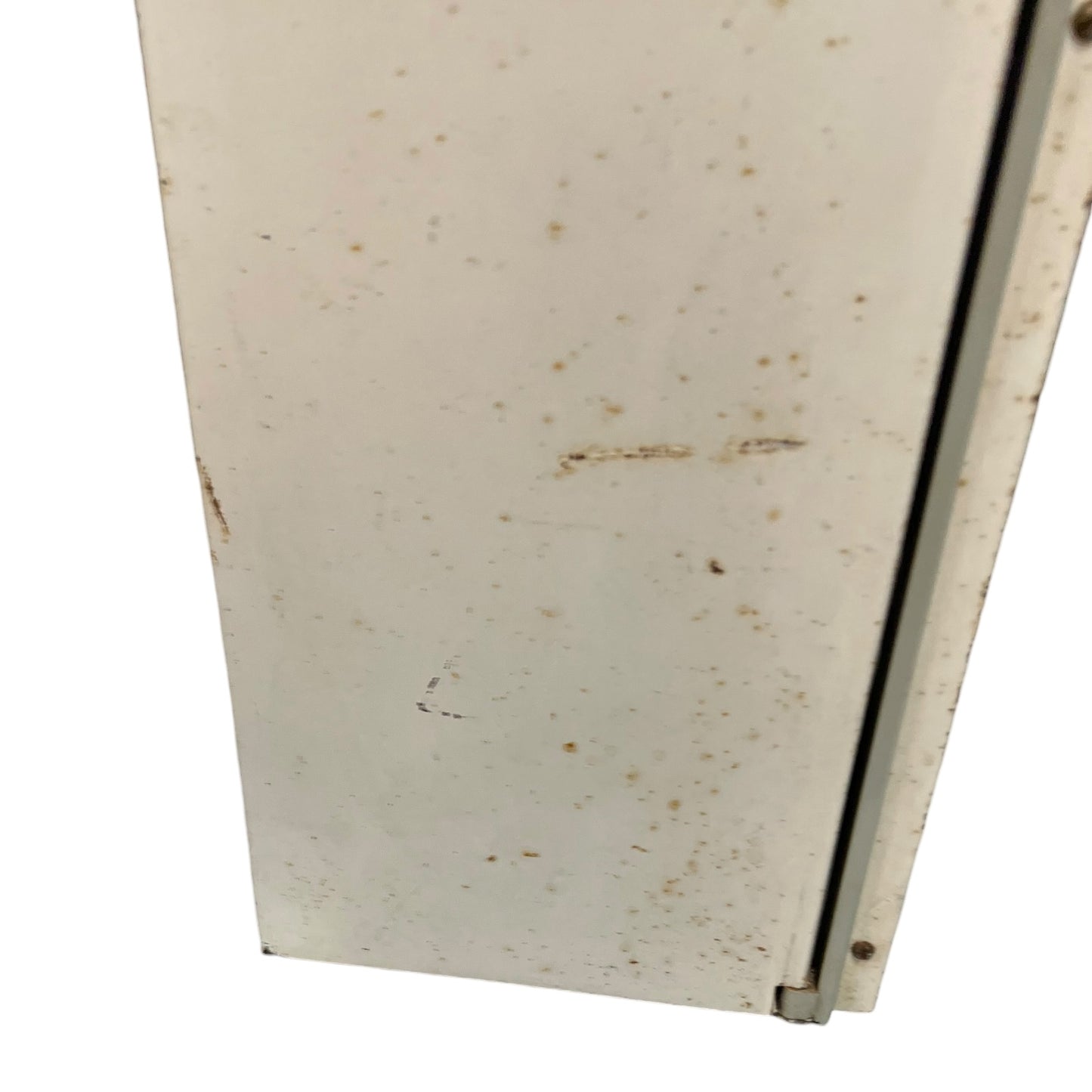 close up of a vintage metal bathroom cabinet on a white background