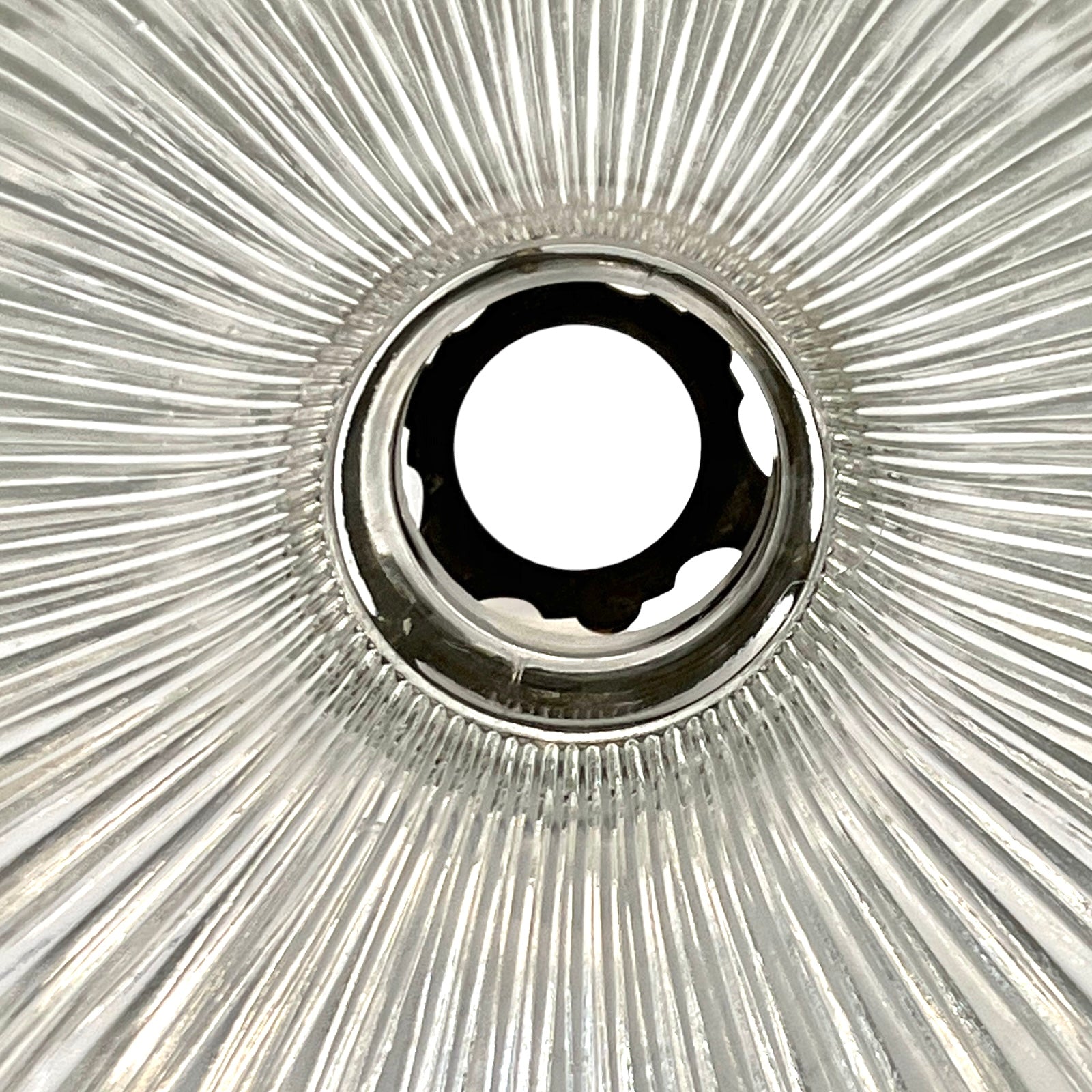 Close-up of a metallic gear with a starburst pattern