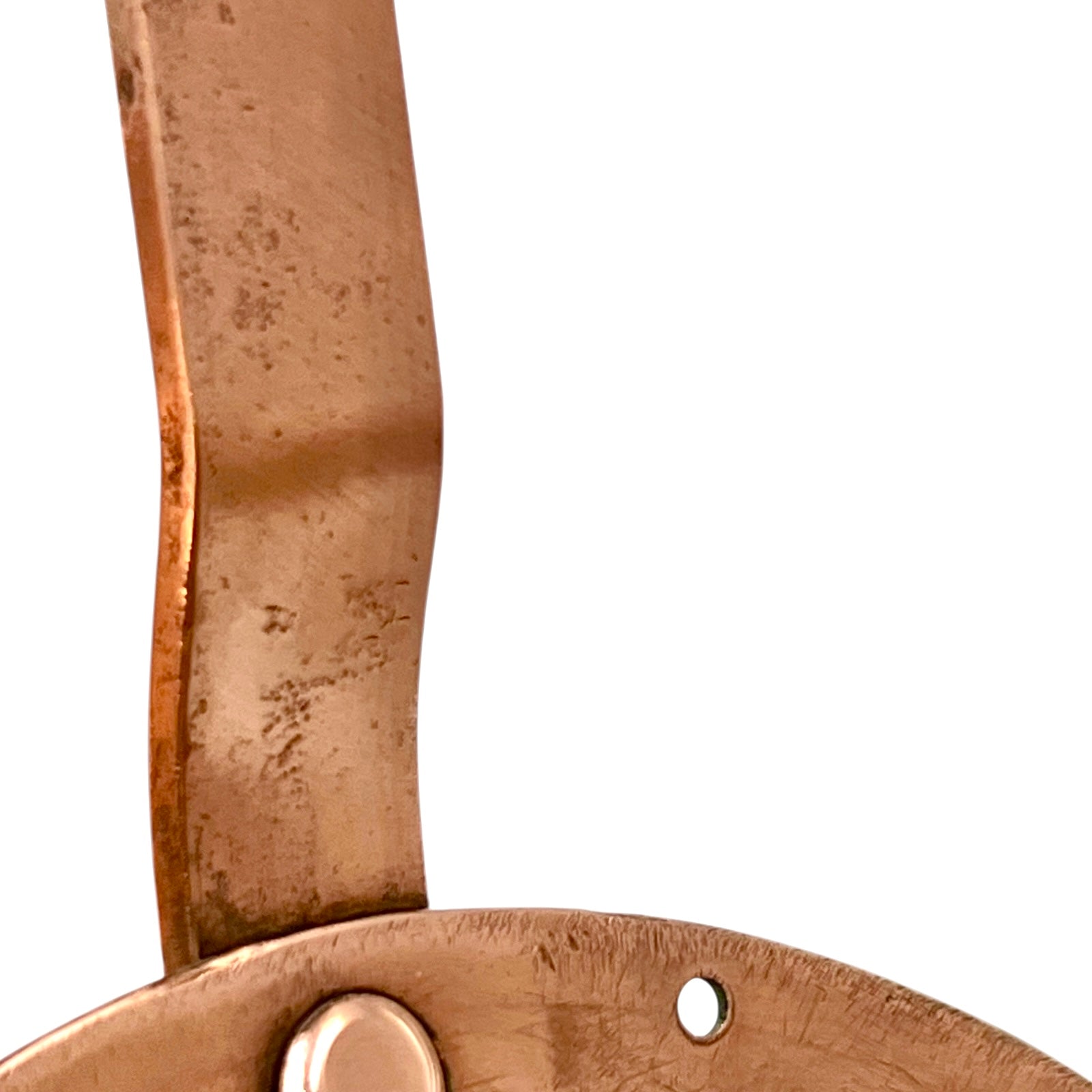 Close-up of a  copper-coloured metal object on a white background