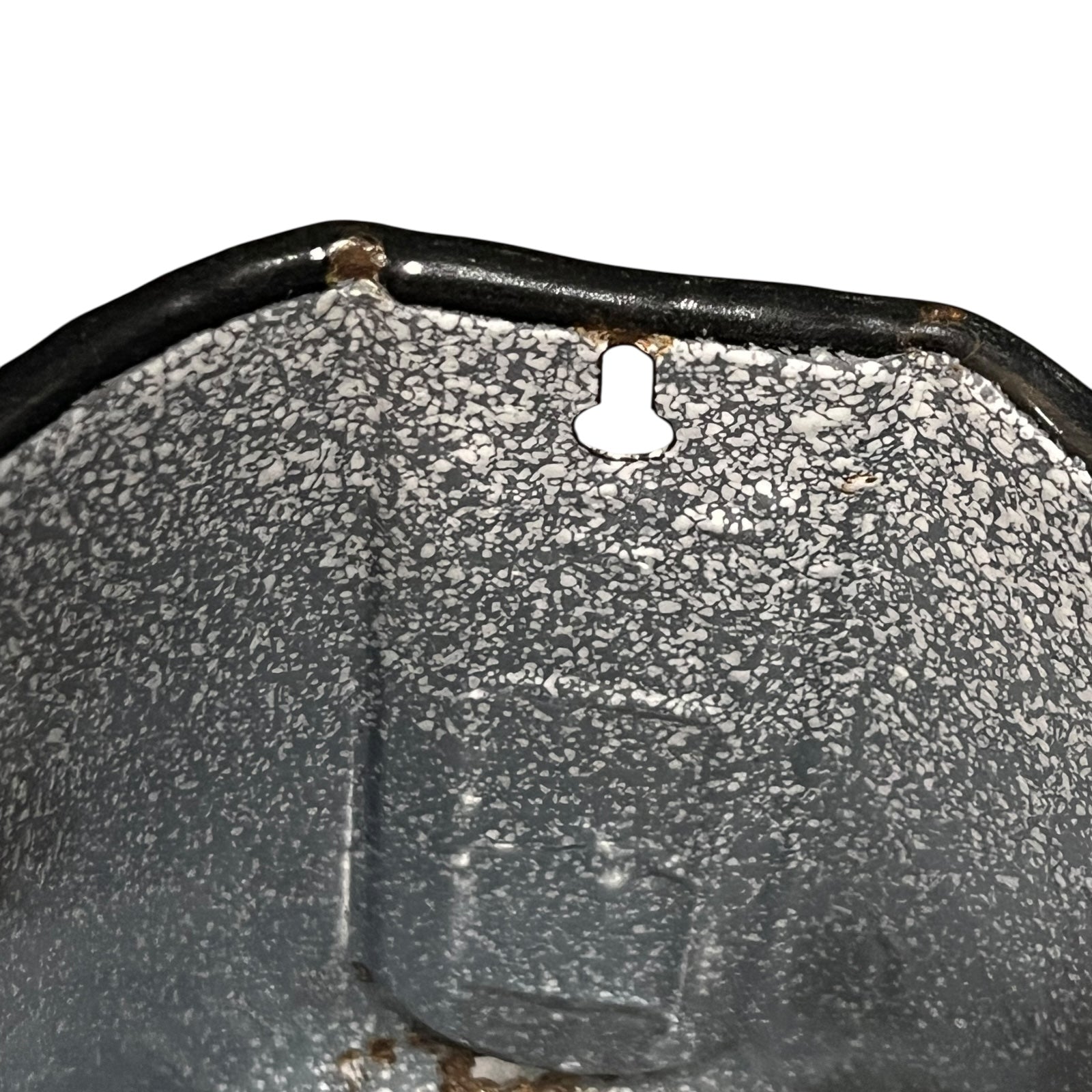 close up of vintage French grey and white speckled irrigator with a spout and a handle showing wear and tear on a white background