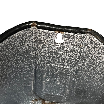 close up of vintage French grey and white speckled irrigator with a spout and a handle showing wear and tear on a white background