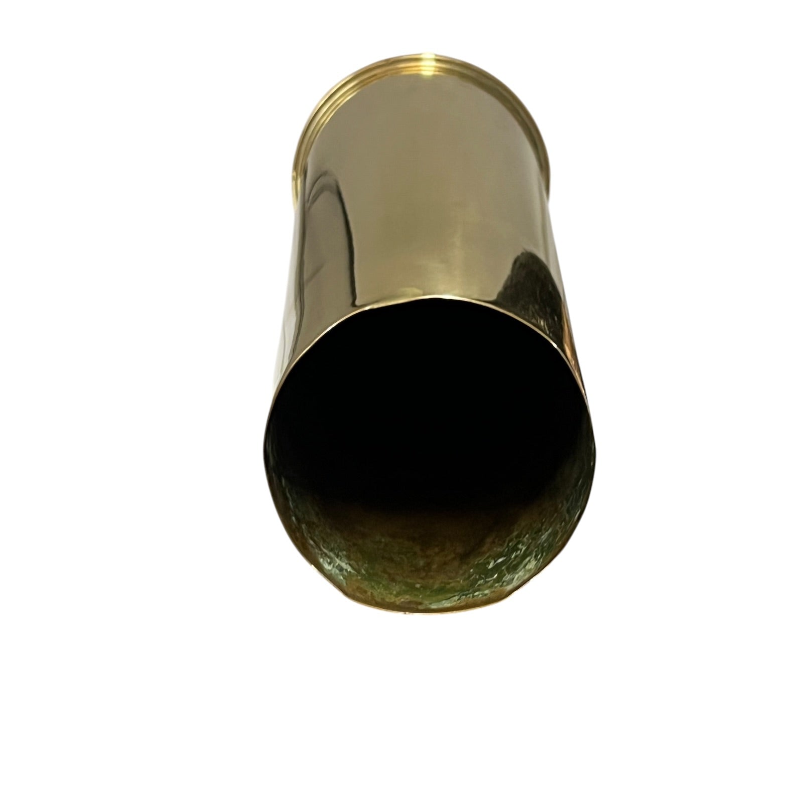 A polished brass cylindrical shell
Case  shown from a top-down perspective against a solid white background.