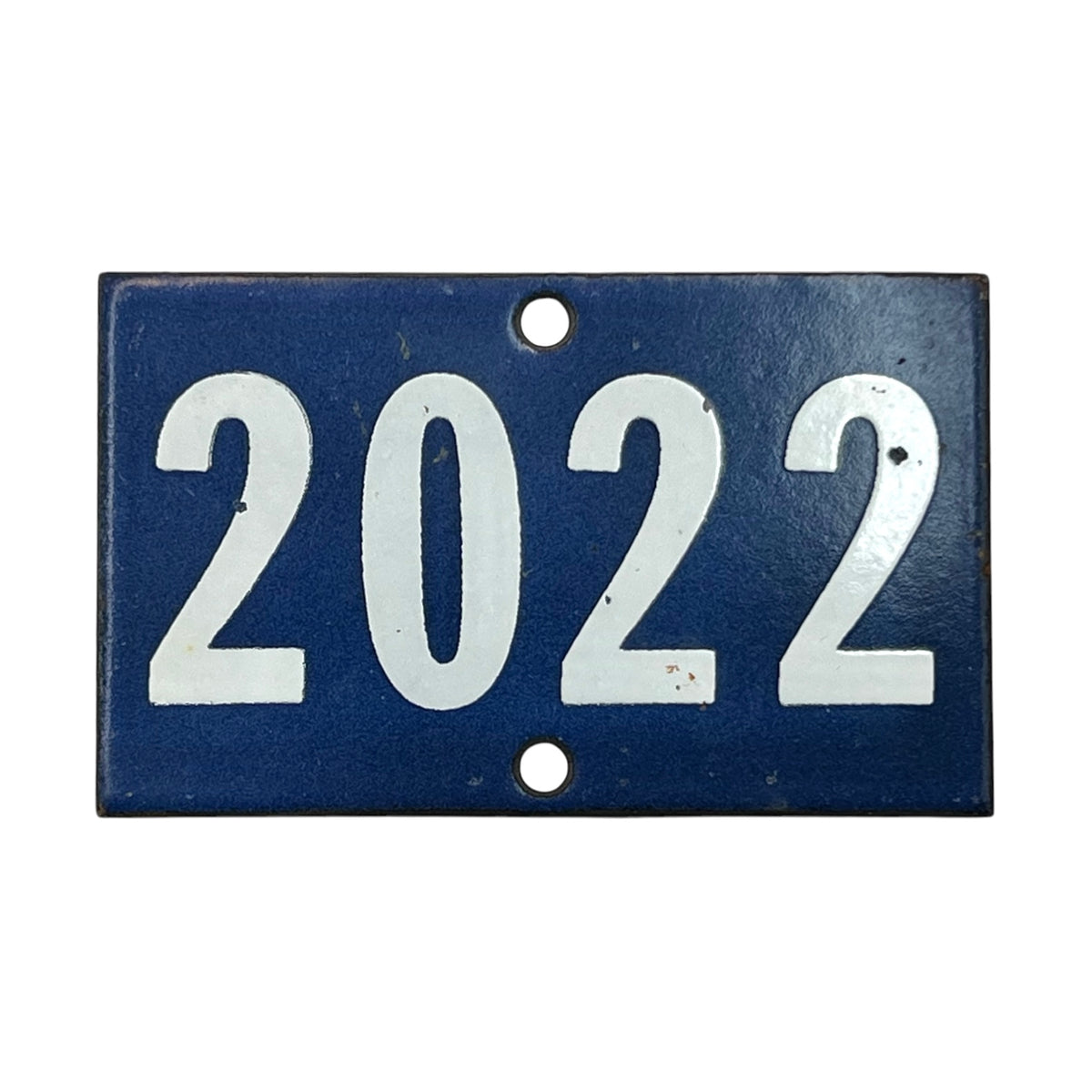 A rectangular vintage-style blue house number plaque with the year '2022' in large white numerals, featuring two mounting holes.