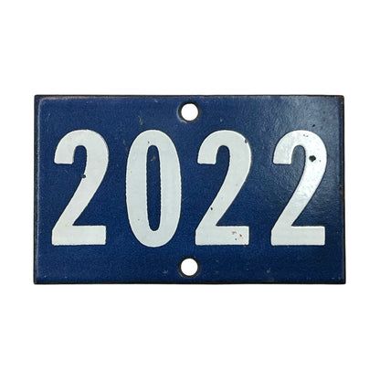 A rectangular vintage-style blue house number plaque with the year '2022' in large white numerals, featuring two mounting holes.