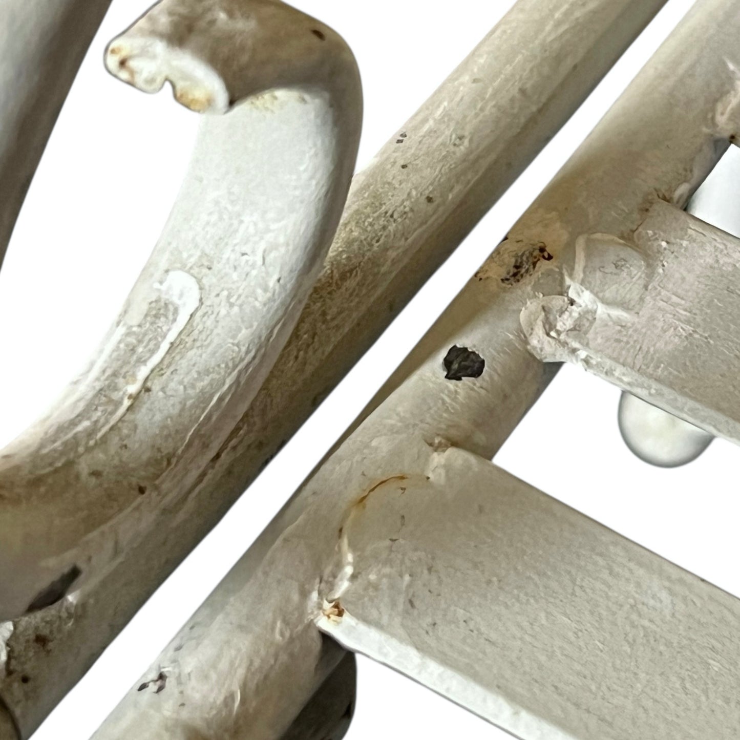 Close-up of a metal she with visible wear and tear on a white background