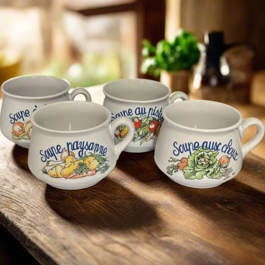 Four ceramic mugs with vegetable illustrations and text on a wooden surface.