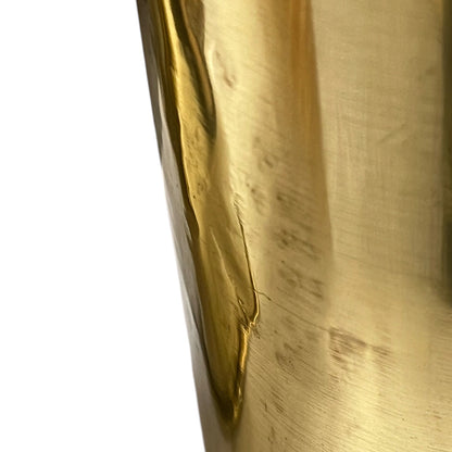 Close up of a brass WW1 German shell case on a white background