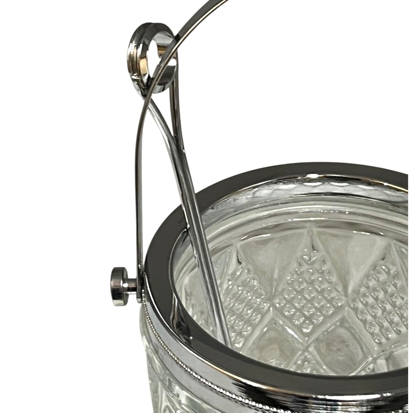 Close-up of a crystal ice bucket with silver lid and handle on a white background