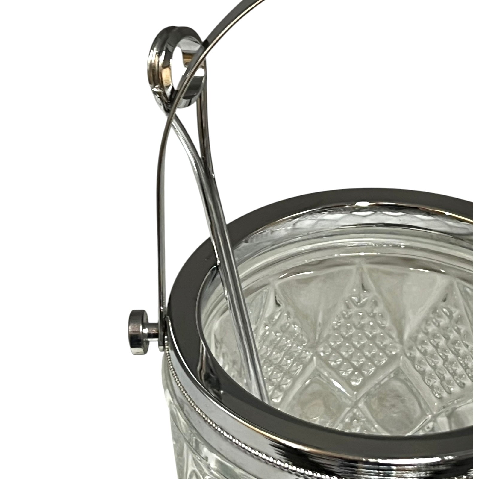 Close-up of a crystal ice bucket with silver lid and handle on a white background