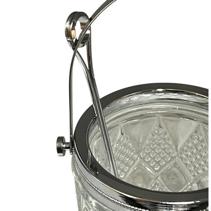 Close-up of a crystal ice bucket with silver lid and handle on a white background