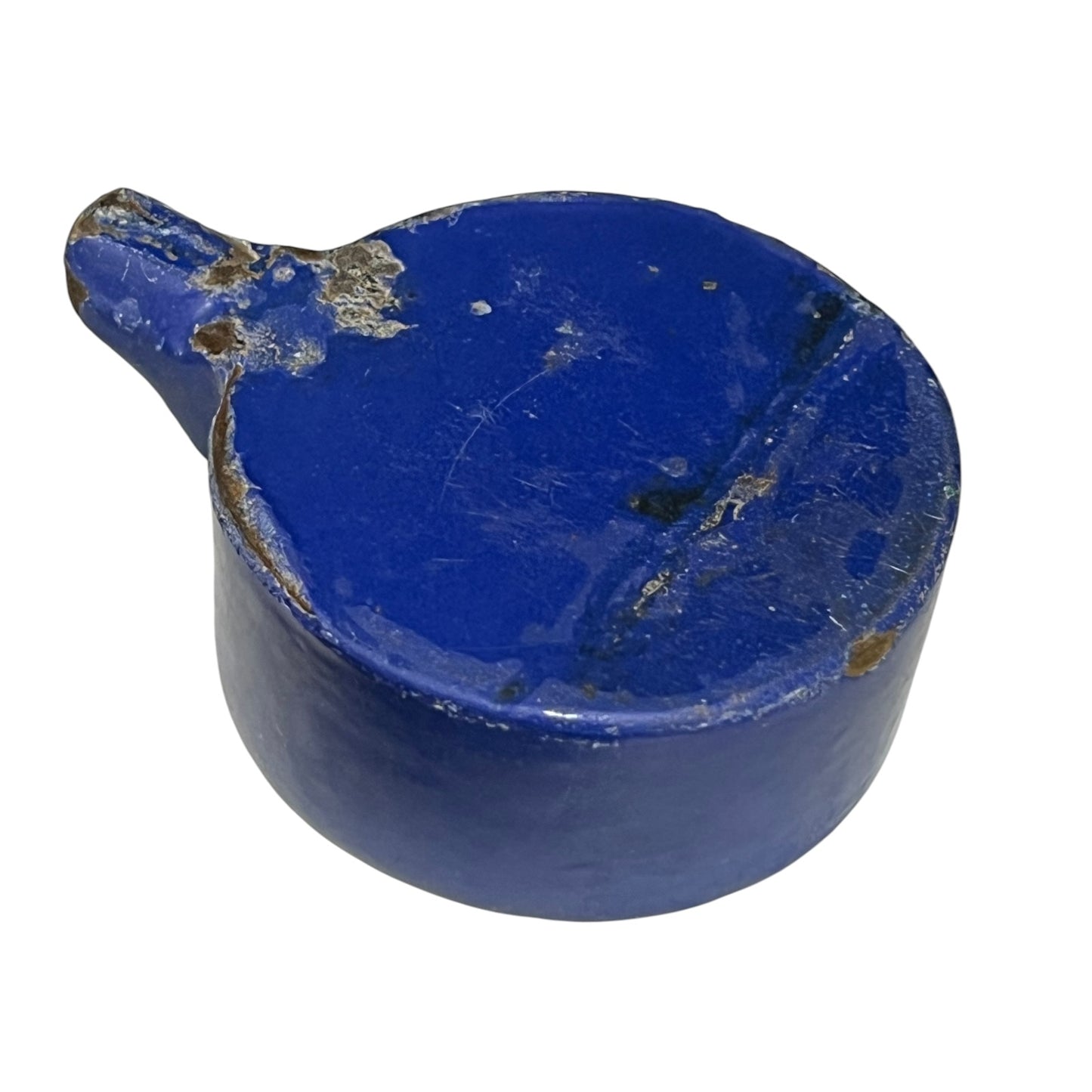 Close-up of a vintage fruit press with a blue pot on a white background