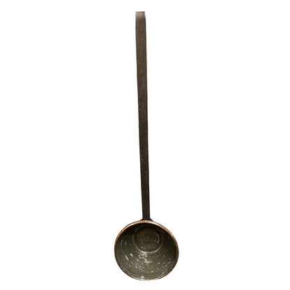 A rustic cast iron ladle with a long handle and a deep, textured bowl, shown vertically against a plain white background.