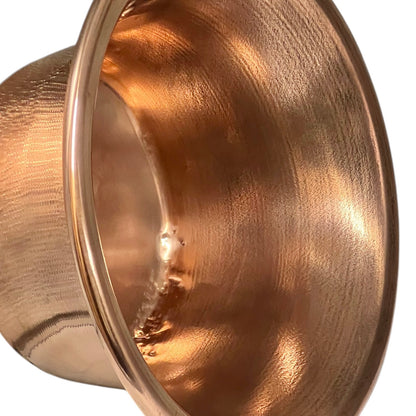 Close up of French vintage copper ladle pan with a black handle on a white background