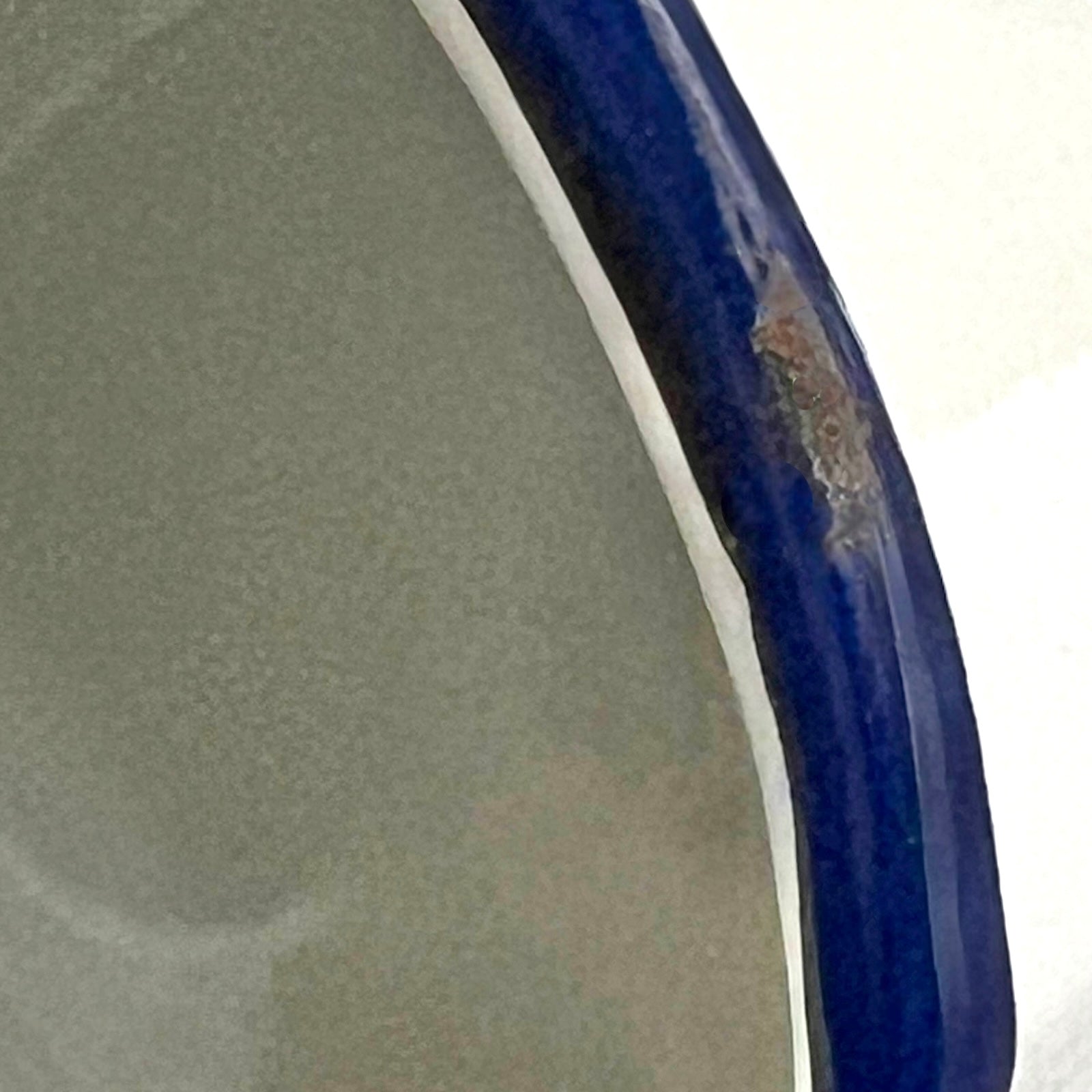 Close-up of a blue rim with a textured surface on a white background