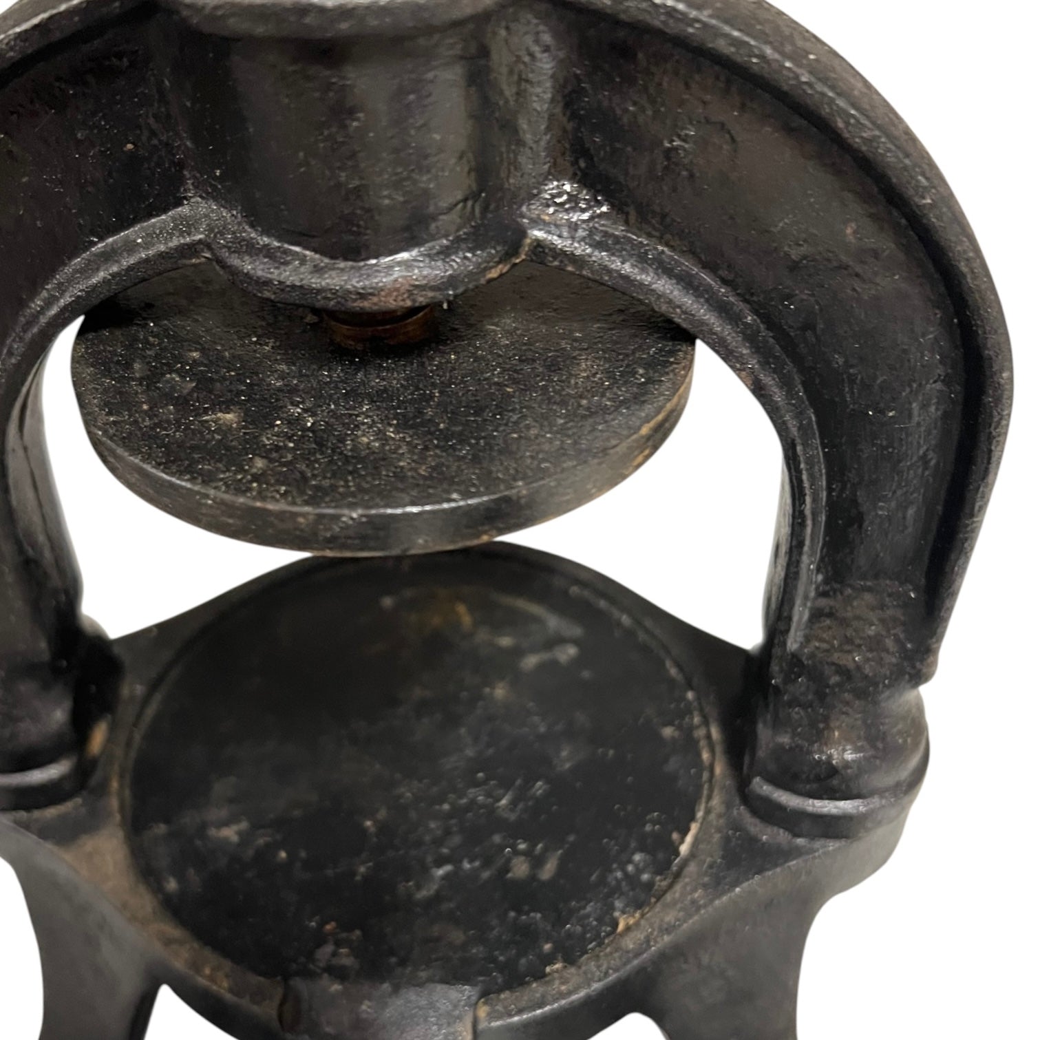 Close-up of a black metal clamp on a white background