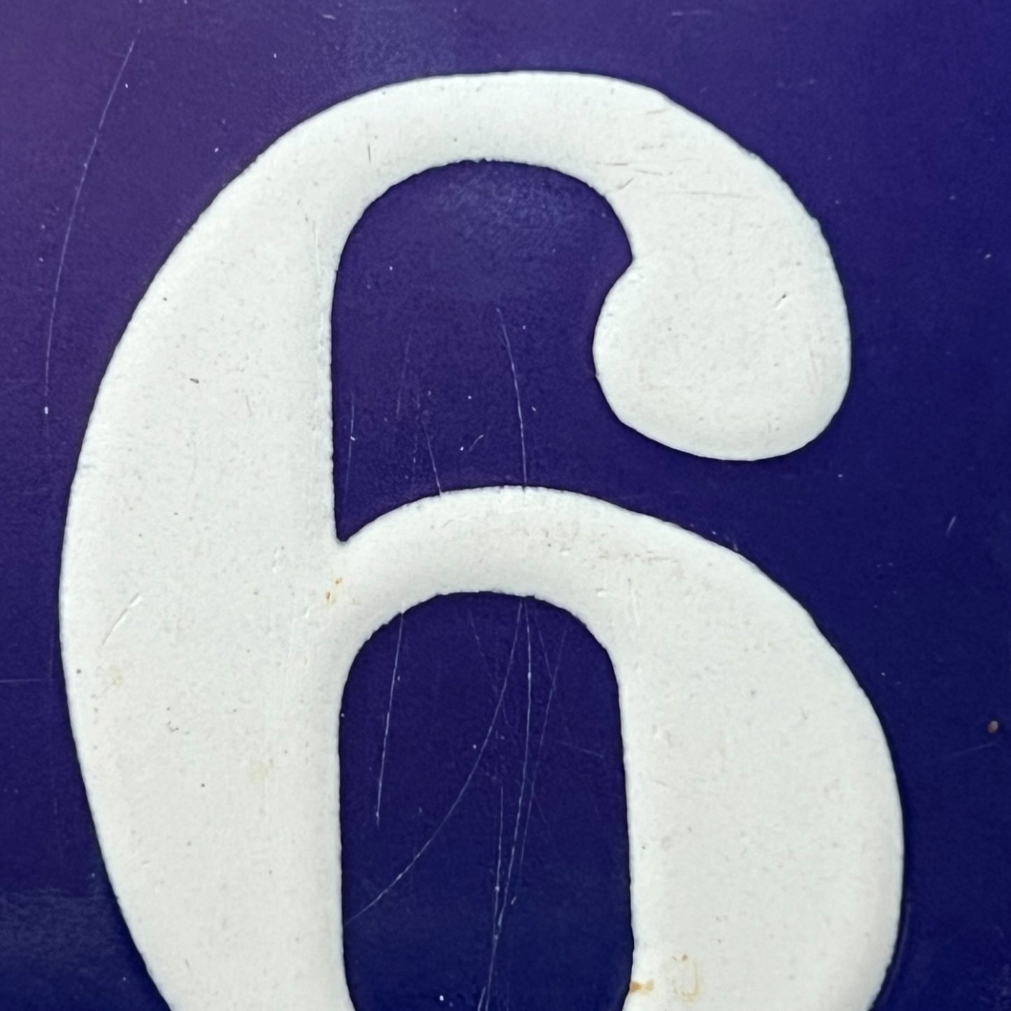 White number '6' on a blue background
