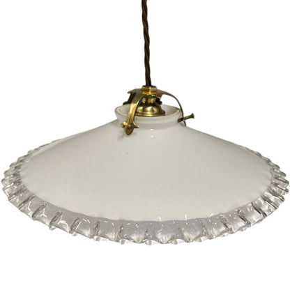 A vintage-style pendant light with a white glass shade featuring a scalloped, fluted edge and a brass metal fixture, suspended by a dark cord against a white background.