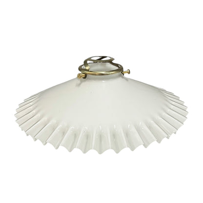 White pleated lampshade with brass fitting on a white background