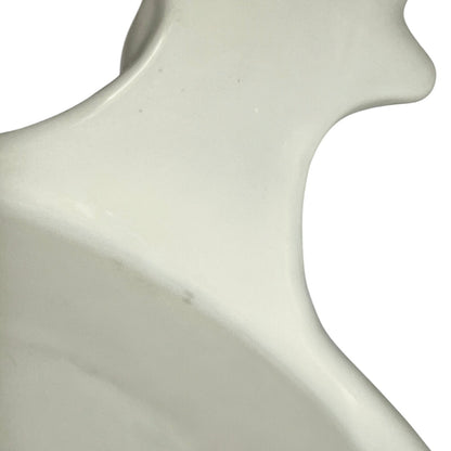 close up of a vintage French L'Hirondelle porcelain cheese dish with cow-shaped white base and illustrated Fromage lid, traditional French farmhouse cheese server.