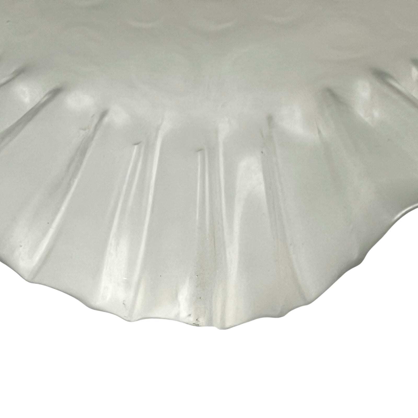 Close up of a French vintage frosted glass lampshade with a frilled scalloped style edge  on a white background