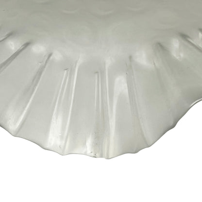 Close up of a French vintage frosted glass lampshade with a frilled scalloped style edge  on a white background