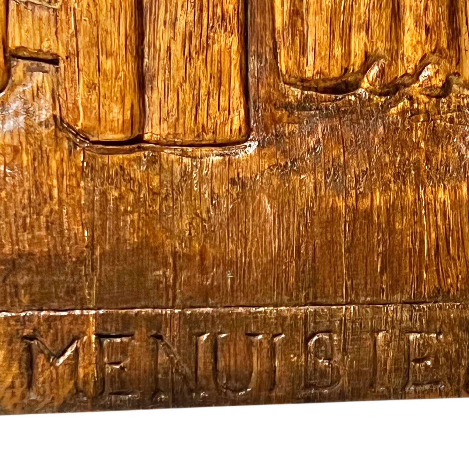 Close-up of a wooden picture with 'MENUSIERE' on a white background.