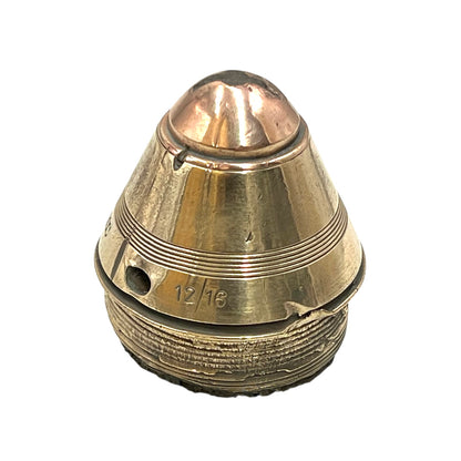 Polished British brass WW1 fuse or paperweight type 101 on a white background