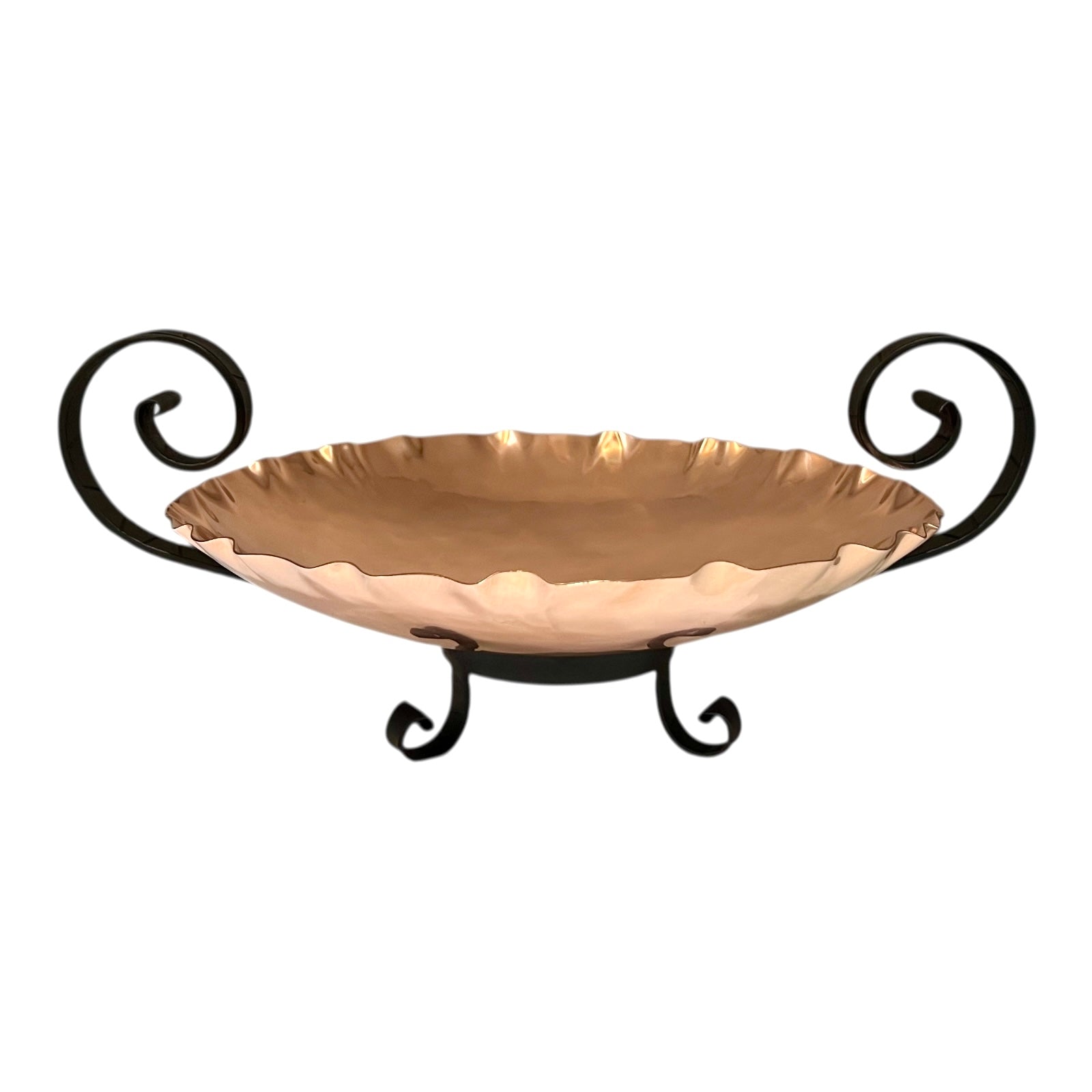 Decorative copper bowl with scrolled handles on a white background