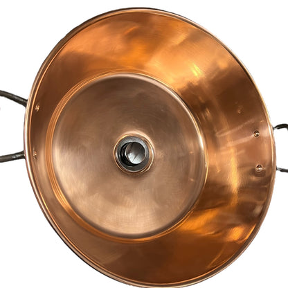 French copper bowl upcycled into a copper sink with iron handles and a chrome pop up waste on a white background
