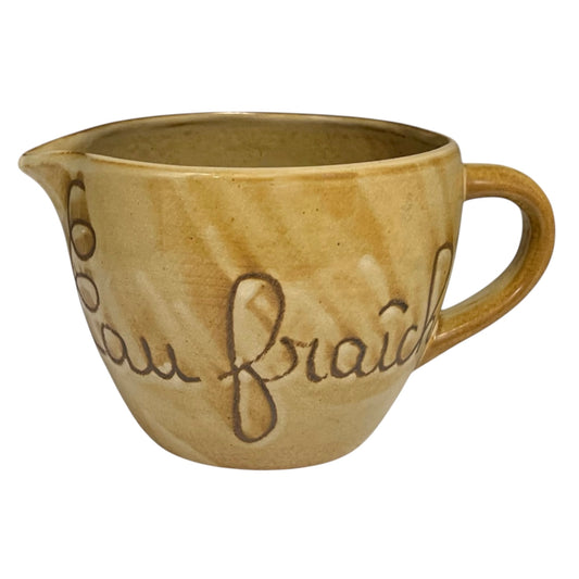 Ceramic pitcher with 'eau fraiche' text on a white background