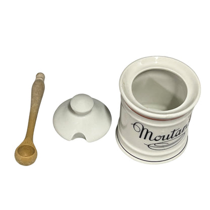 White ceramic mustard container with wooden spoon and lid on a white background