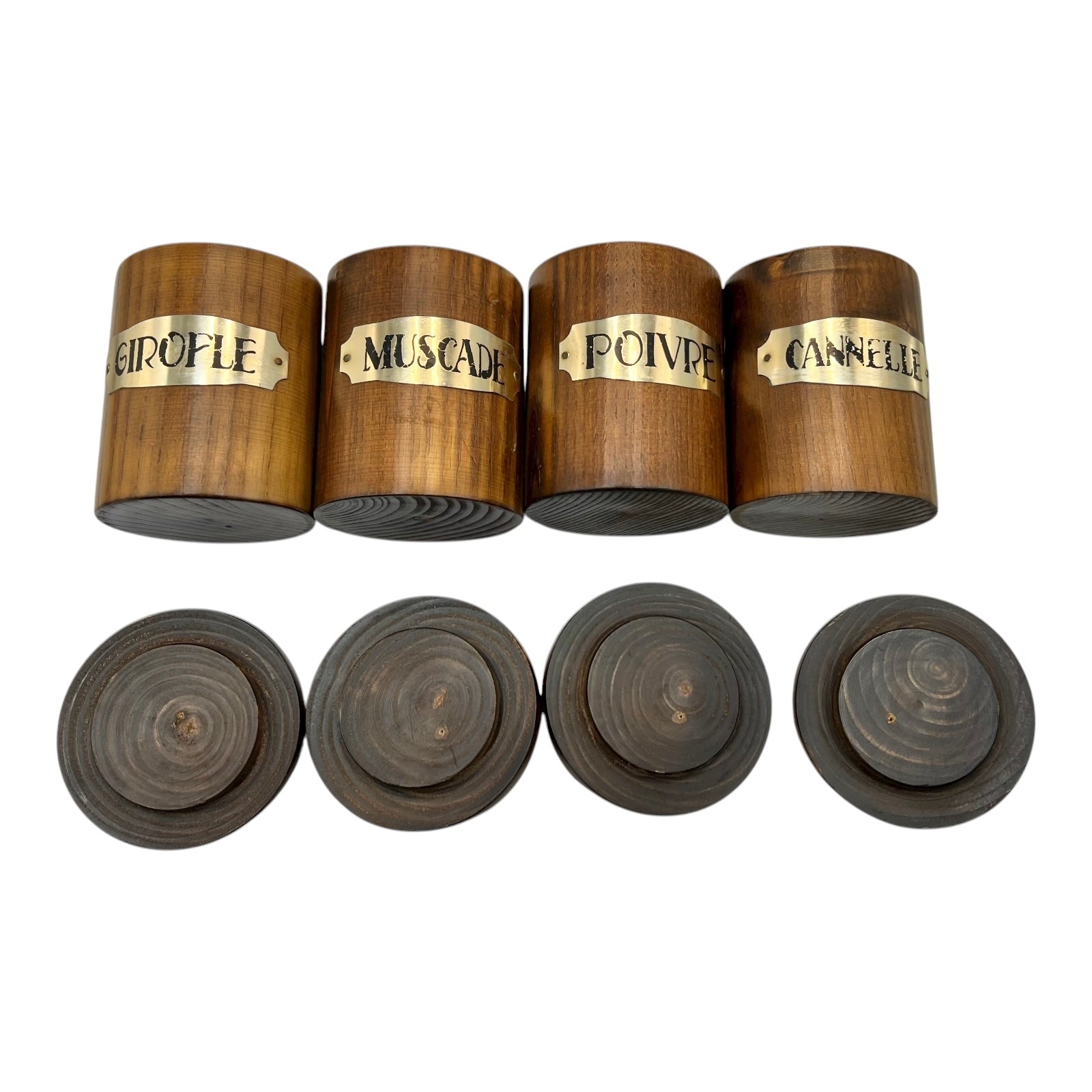 Set of wooden spice jars with gold labels on a white background