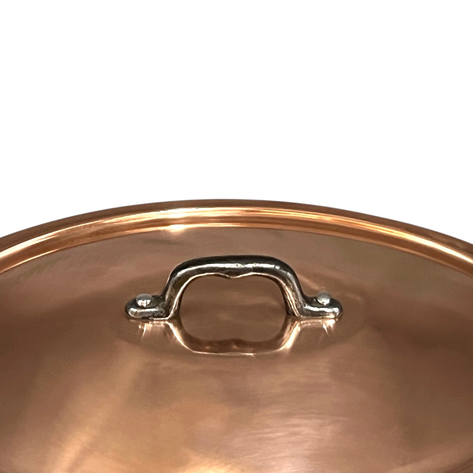 Close-up of a copper pot handle on a white background