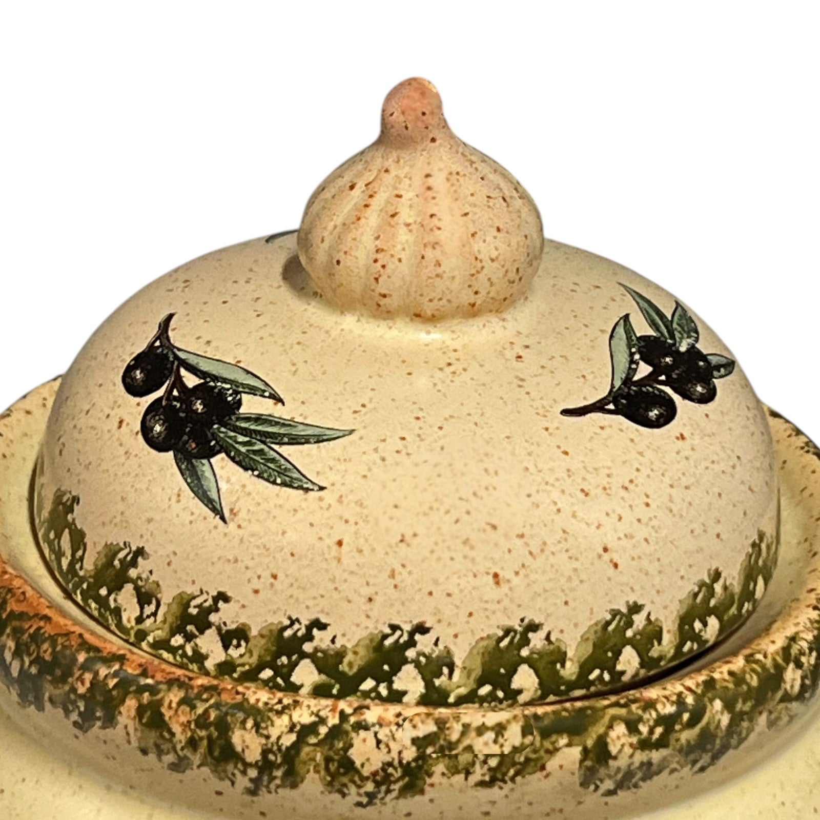 Close-up of a ceramic jar with embossed design on a white background
