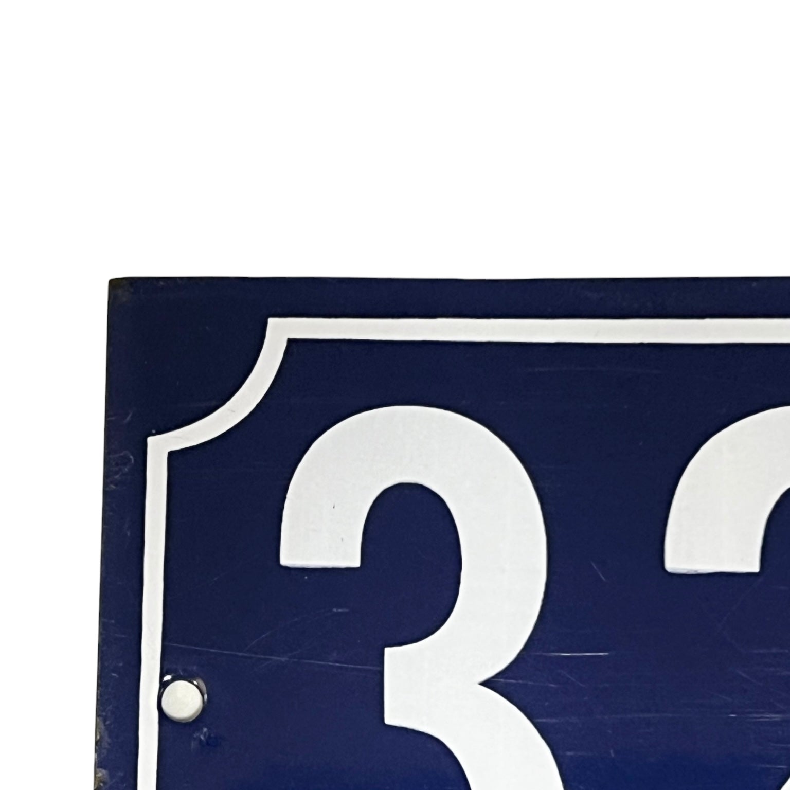 Close up of a French enamel door number 32 on a white background 