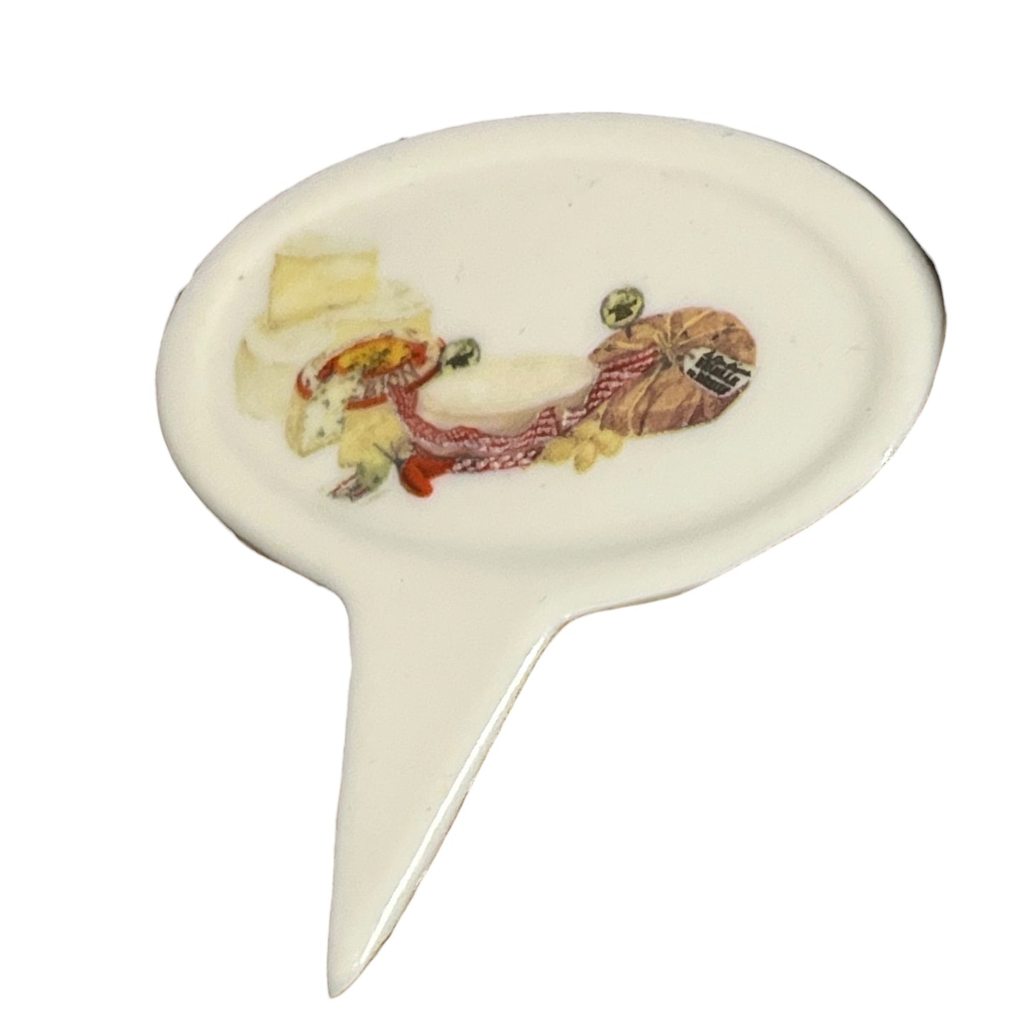 Decorative ceramic cheese label with a design of food items on a white background