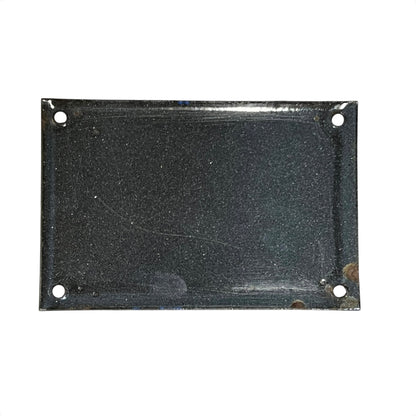 Rectangular black metal plate with holes on a white background