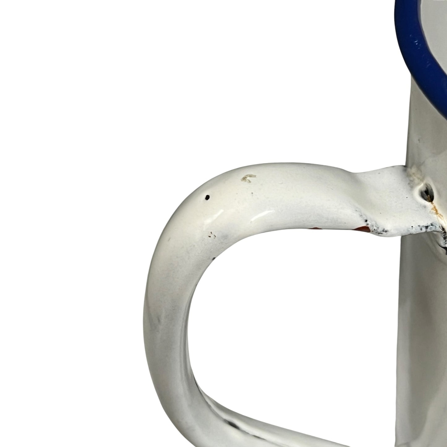 Close-up of a white enamel handle with a blue rim, showing some wear and scuffs on a white background.