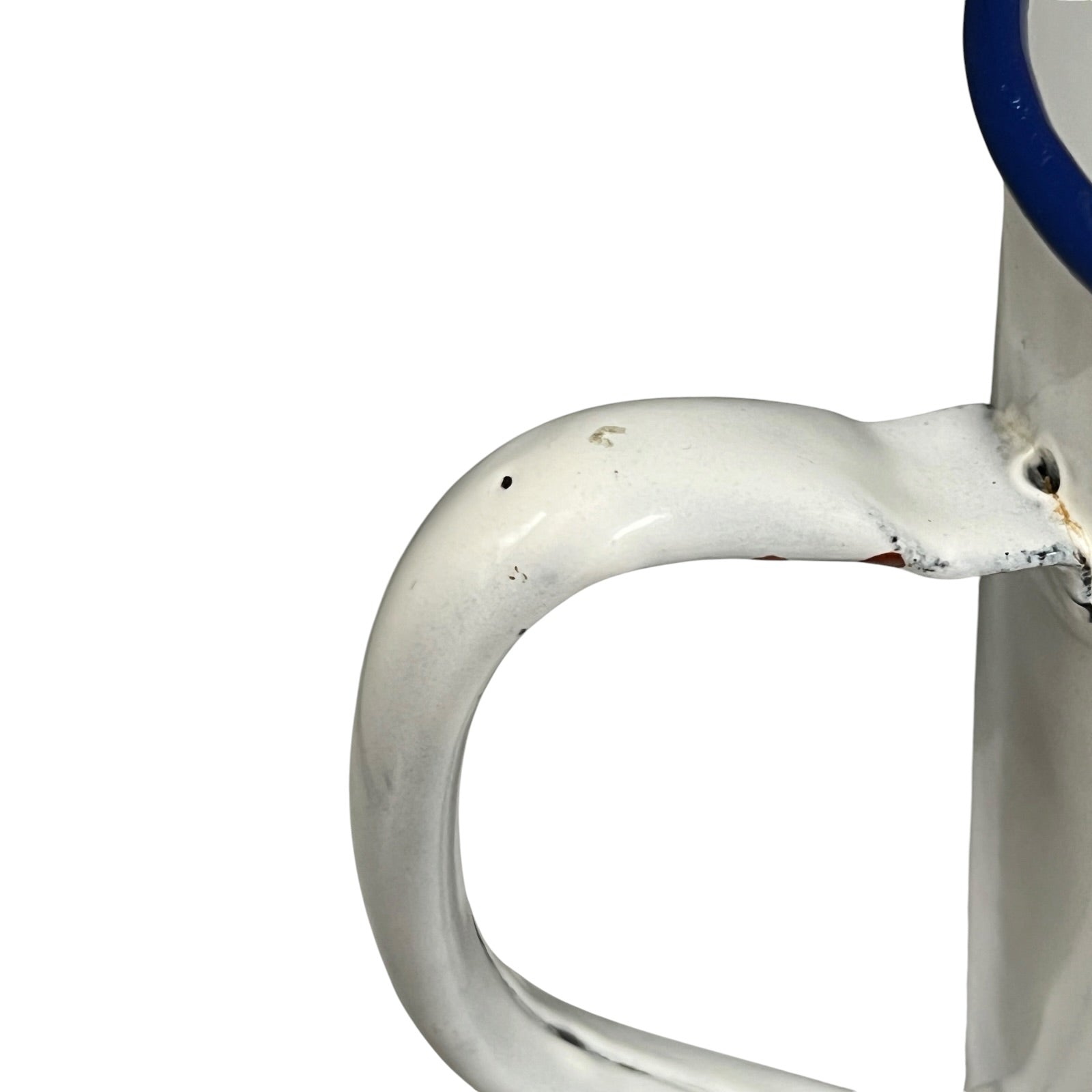 Close-up of a white enamel handle with a blue rim, showing some wear and scuffs on a white background.