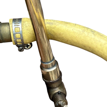 close up of a French copper garden sprayer on a white background 