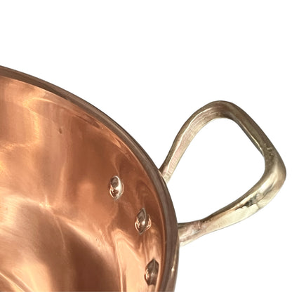 Close up of a copper basin sink on a white background