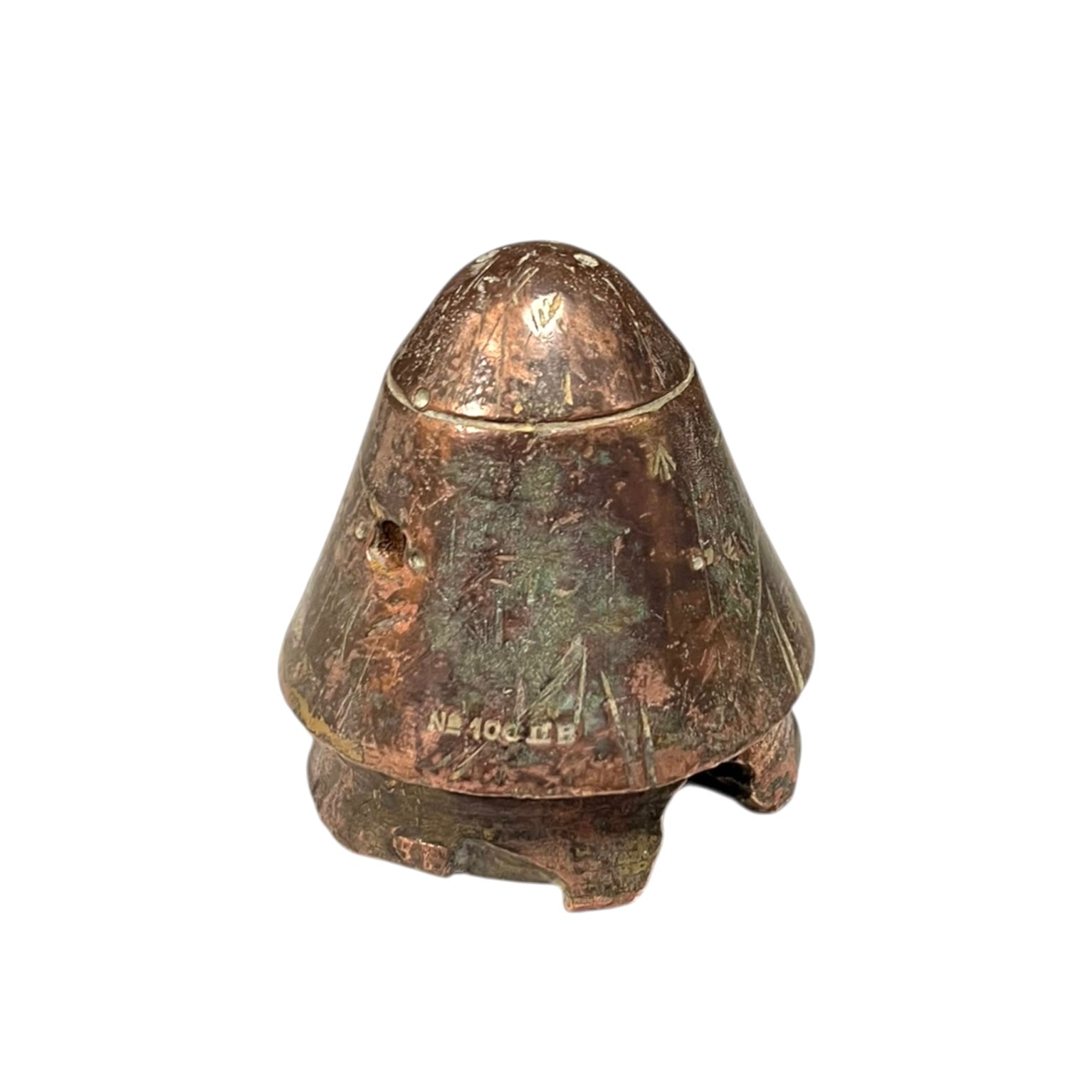 WW1 British brass fuse now repurposed as a paperweight on a white background