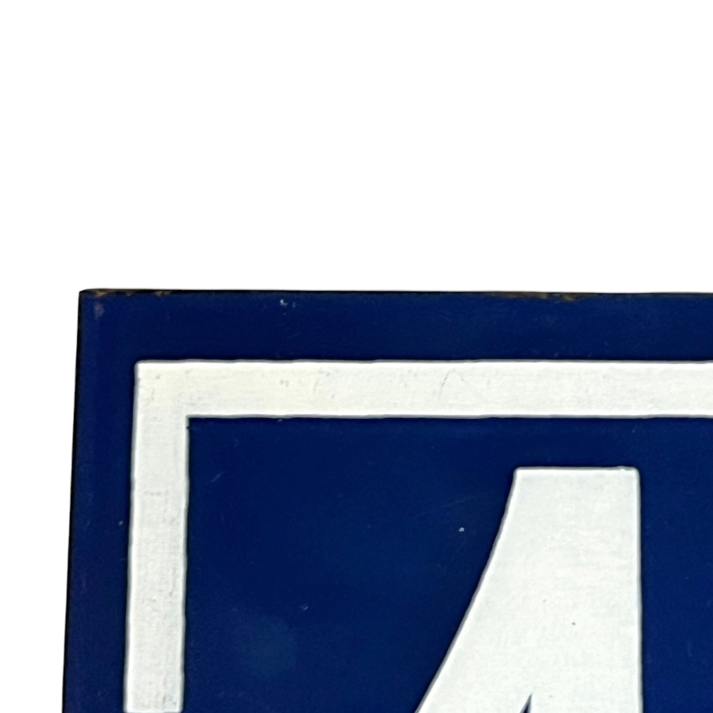 Close up of a French enamel door number on a white background 