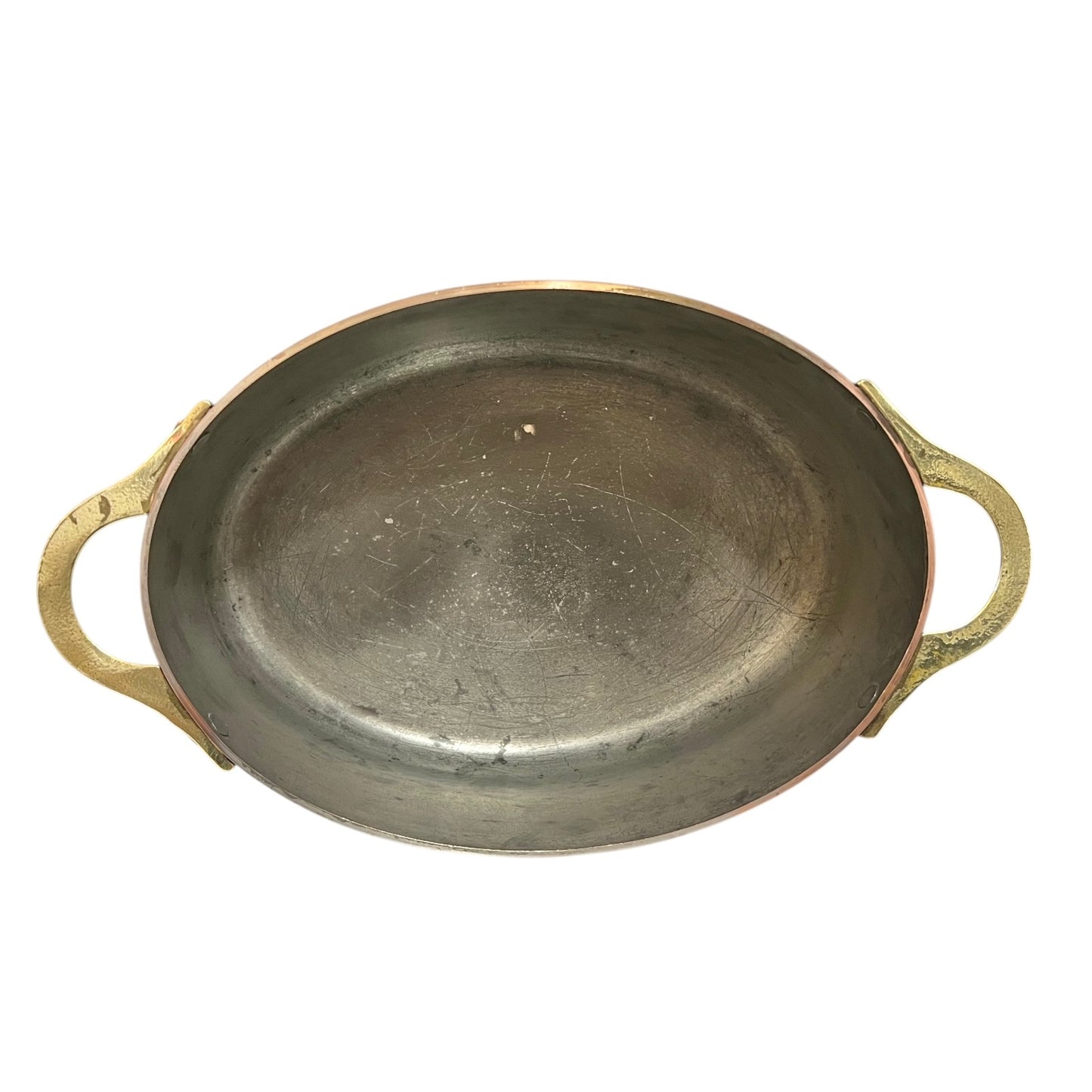 Inside of a French copper pan with tin lining on a white background