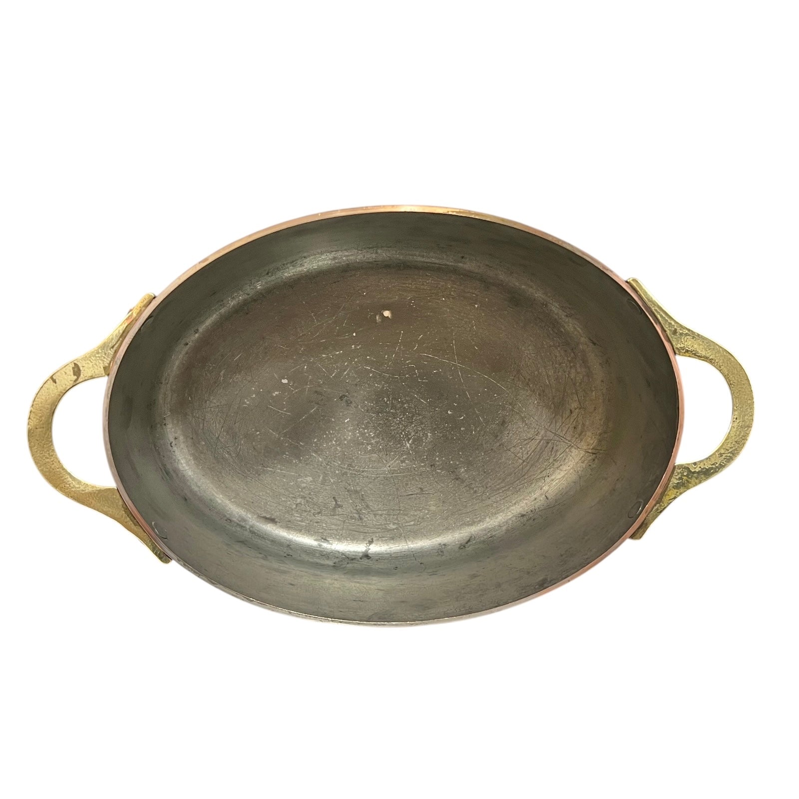 Inside of a French copper pan with tin lining on a white background
