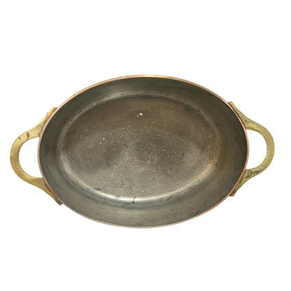 Inside of a French copper pan with tin lining on a white background